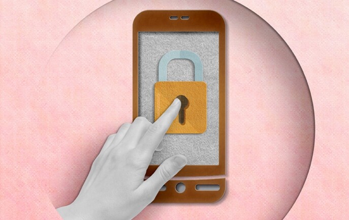 A hand is touching a phone with a padlock on it